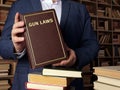 GUN LAWS book in the hands of a jurist. Gun control is one of the most divisive issues in AmericanÃÂ politics